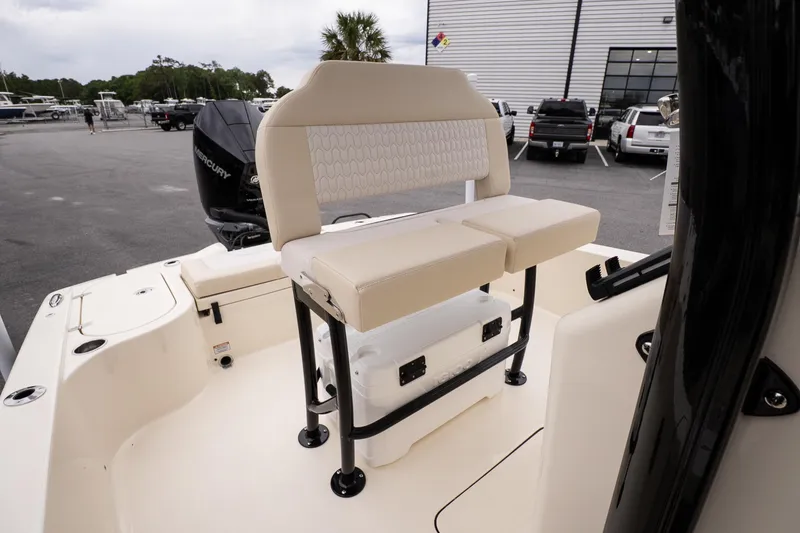 Slide: The Image of 2026 Scout 231 XSB boat interior with cushioned seating and Mercury engine. - 11