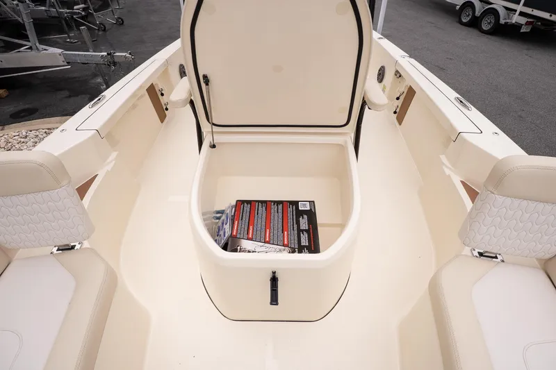 Slide: The Image of Open storage compartment on 2026 Scout 231 XSB boat, showcasing interior space. - 19