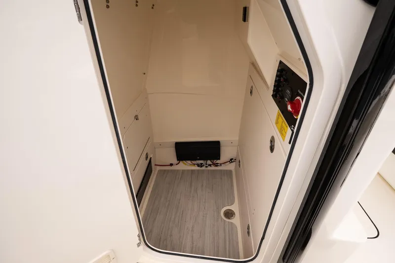 Slide: The Image of Interior cabin of 2026 Scout 231 XSB boat, featuring control panel and storage. - 20