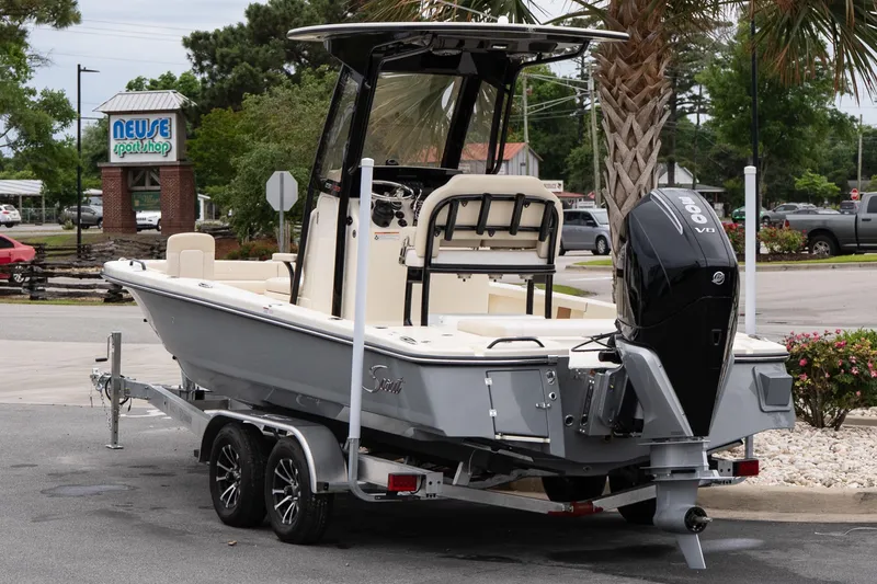 Slide: The Image of 2026 Scout 231 XSB boat on trailer, parked near Neuse Sport Shop. - 4