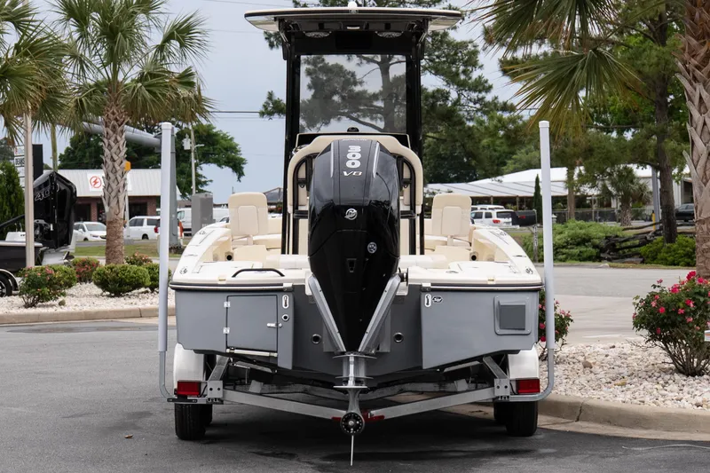 Slide: The Image of 2026 Scout 231 XSB boat on trailer, rear view, parked near palm trees. - 5