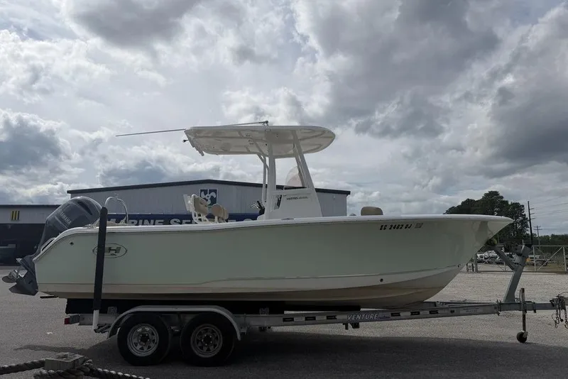 Slide: The Image of 2018 Sea Hunt Ultra 225 boat on trailer under cloudy sky. - 10