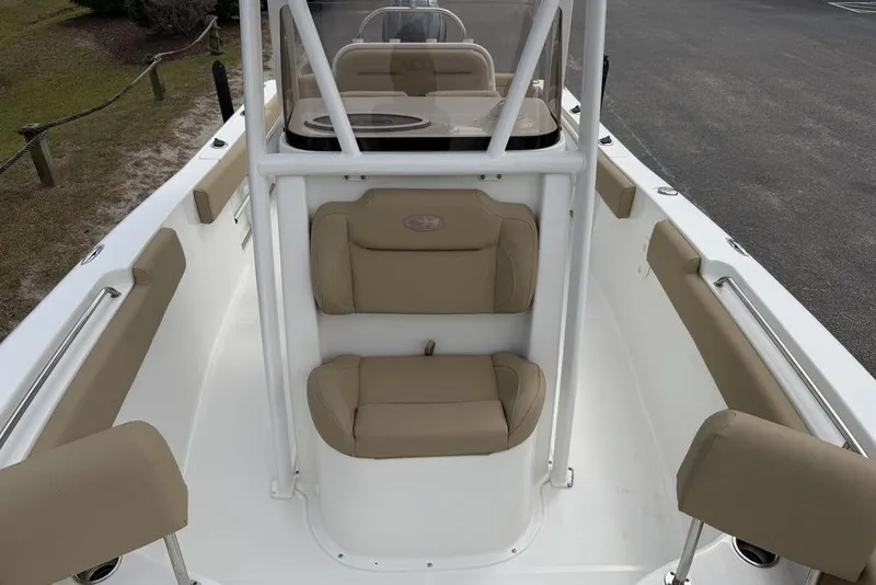 Slide: The Image of 2018 Sea Hunt Ultra 225 boat interior with beige seating and white framework. - 11