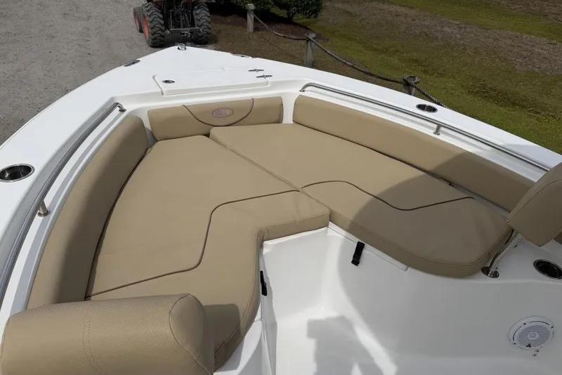 Slide: The Image of 2018 Sea Hunt Ultra 225 boat with beige cushioned seating area. - 12