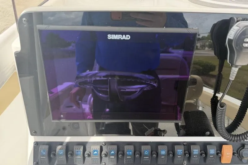 Slide: The Image of Simrad display and controls on 2018 Sea Hunt Ultra 225 boat dashboard. - 15