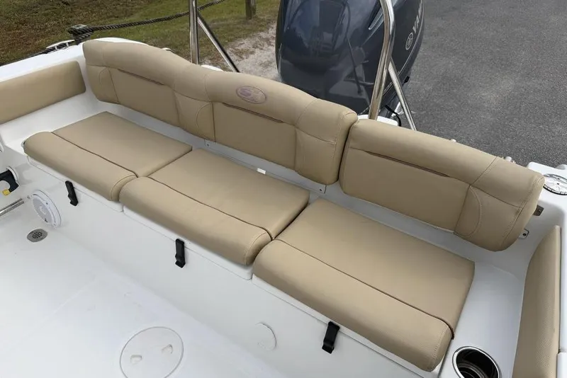 Slide: The Image of 2018 Sea Hunt Ultra 225 boat with beige cushioned seating and Yamaha engine. - 18