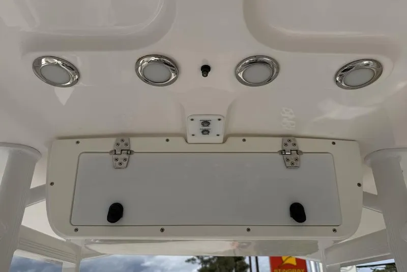 Slide: The Image of 2018 Sea Hunt Ultra 225 boat console with lights and storage compartment. - 19