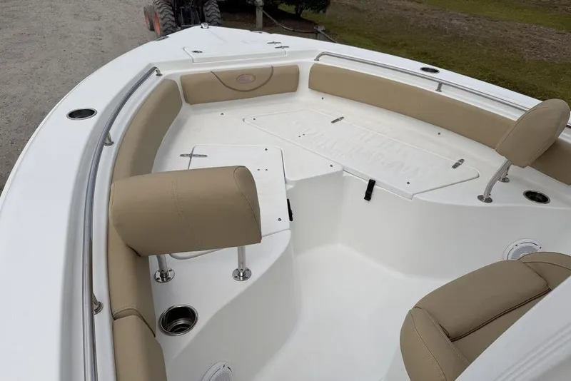 Slide: The Image of 2018 Sea Hunt Ultra 225 boat interior with beige seating and storage compartments. - 6