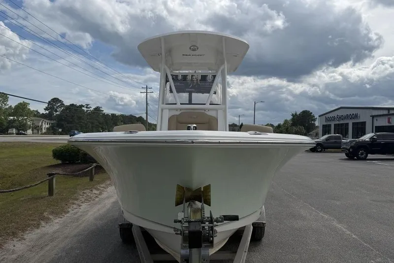 Slide: The Image of 2018 Sea Hunt Ultra 225 boat on trailer, parked outdoors under cloudy sky. - 7