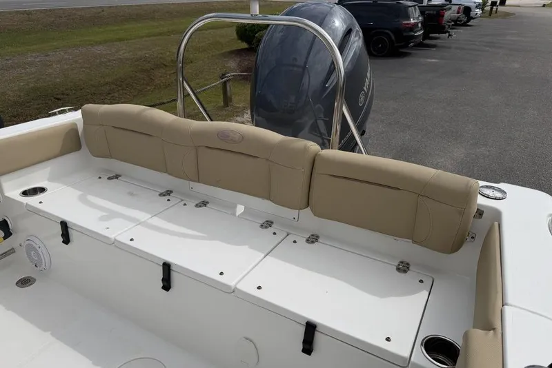 Slide: The Image of 2018 Sea Hunt Ultra 225 boat interior with beige seating and storage compartments. - 8