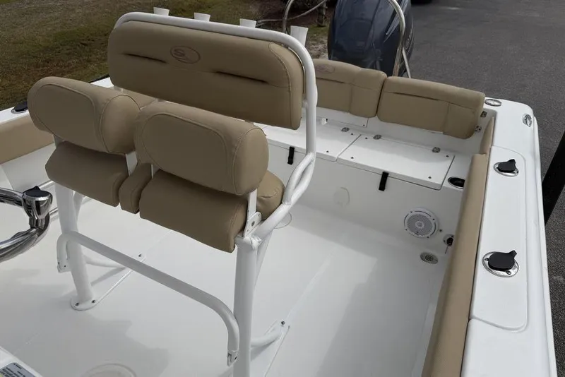 Slide: The Image of 2018 Sea Hunt Ultra 225 boat interior with beige seating and white deck. - 9