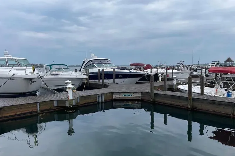 Slide: The Image of Docked boats at marina featuring 2012 Cruisers Yachts 380 Express under cloudy sky. - 17