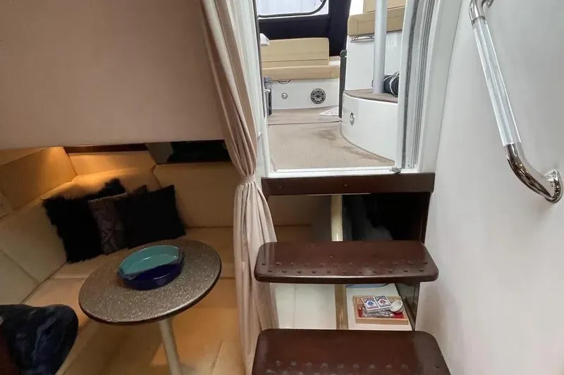 Slide: The Image of Interior view of 2012 Cruisers Yachts 380 Express, featuring cozy seating and elegant stairs. - 8