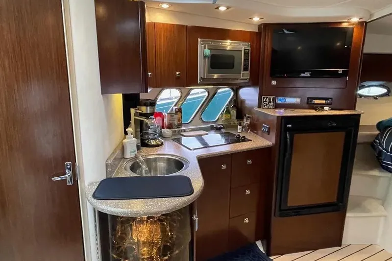 Slide: The Image of Luxurious 2012 Cruisers Yachts 380 Express interior with kitchenette and modern amenities. - 9