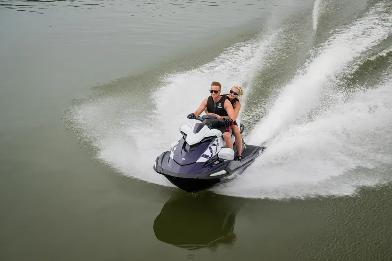 Slide: The Image of Two people riding a 2026 Yamaha WaveRunner VX Cruiser HO on a lake. - 18
