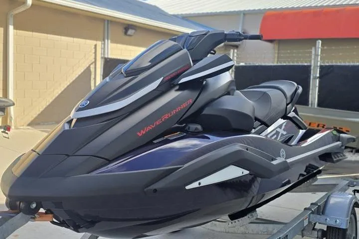 The Image of 2026 Yamaha WaveRunner FX SVHO jet ski on trailer, sleek design, black and blue color scheme. - 0