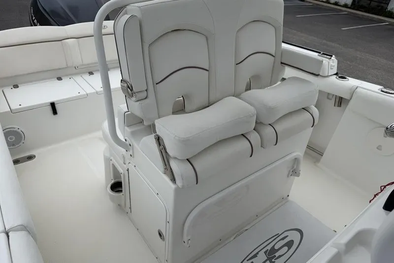 Slide: The Image of 2018 Sea Hunt Ultra 255 SE boat interior with cushioned seating and storage compartments. - 15