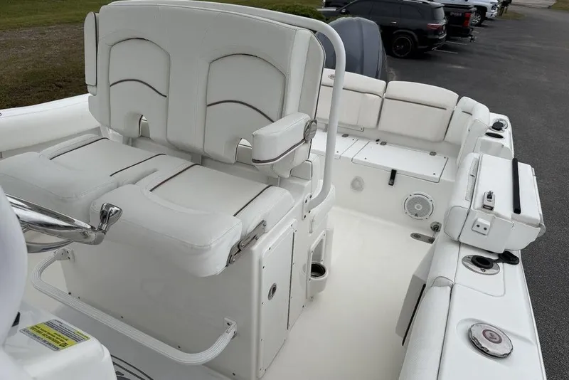 Slide: The Image of 2018 Sea Hunt Ultra 255 SE boat interior with white seating and console. - 17