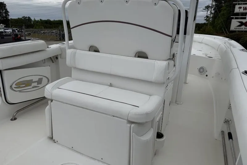 Slide: The Image of 2018 Sea Hunt Ultra 255 SE boat interior with white seating and storage compartments. - 18