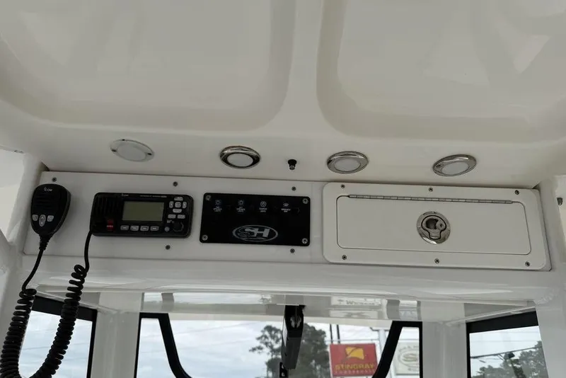 Slide: The Image of 2018 Sea Hunt Ultra 255 SE boat dashboard with radio and control panel. - 19