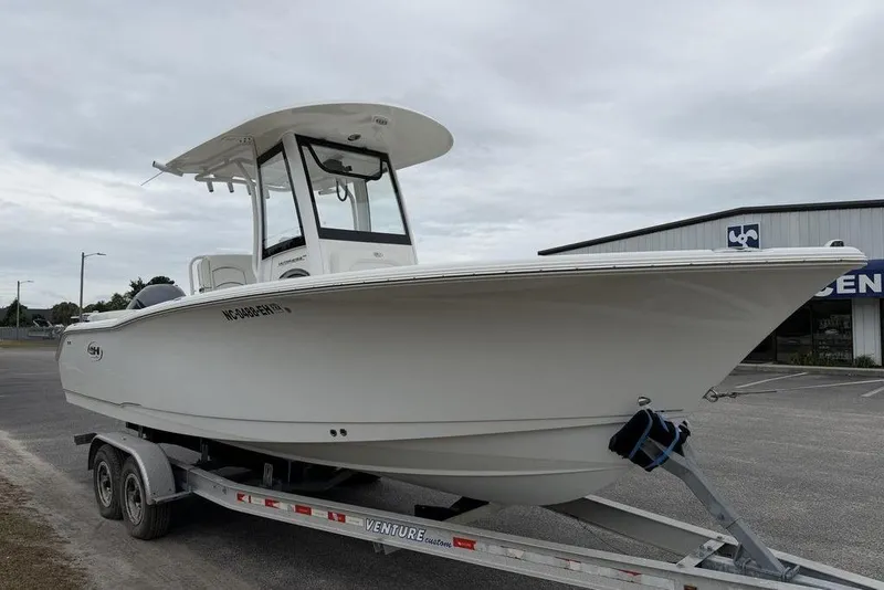 Slide: The Image of 2018 Sea Hunt Ultra 255 SE boat on trailer, parked outdoors. - 6