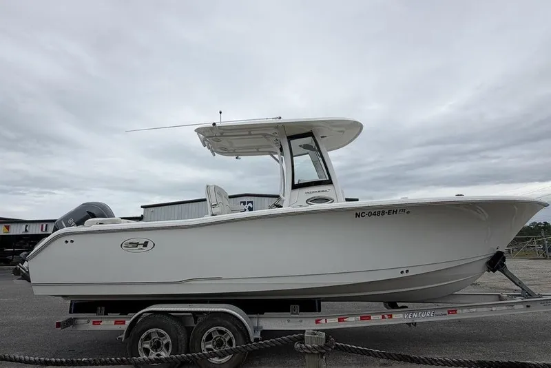 Slide: The Image of 2018 Sea Hunt Ultra 255 SE boat on trailer, side view, overcast sky. - 8