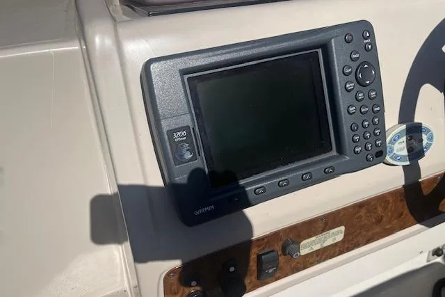 Slide: The Image of Control panel of a 1997 Regal Commodore 322 boat with navigation system. - 10