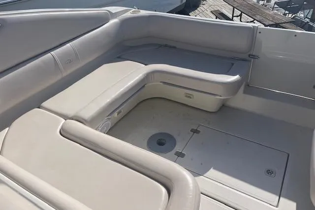 Slide: The Image of 1997 Regal Commodore 322 boat interior with beige seating and storage compartments. - 11