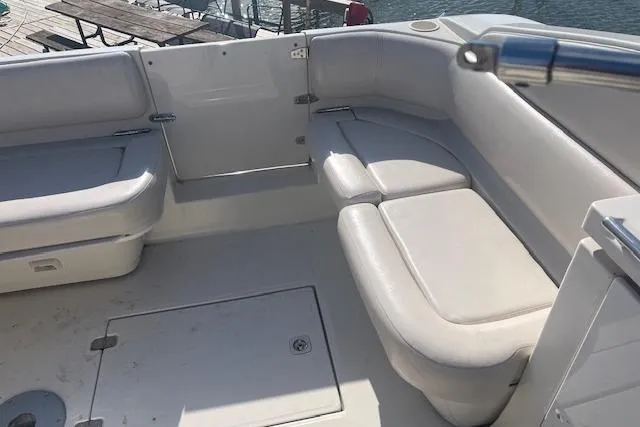 Slide: The Image of 1997 Regal Commodore 322 boat interior with white seating and deck view. - 12