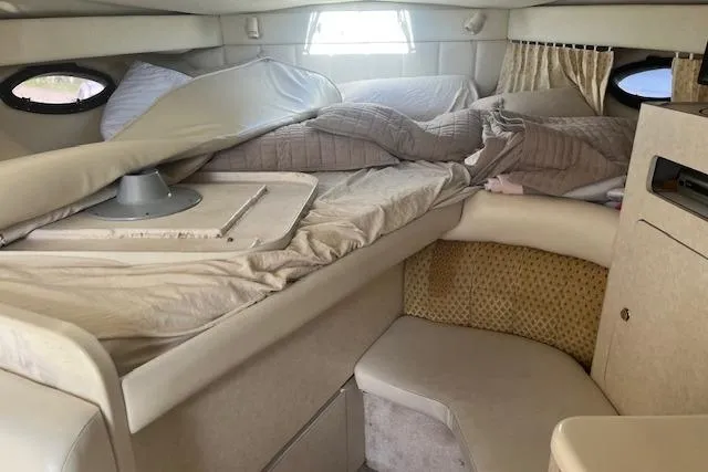 Slide: The Image of Interior cabin of a 1997 Regal Commodore 322 boat with unmade bed. - 18