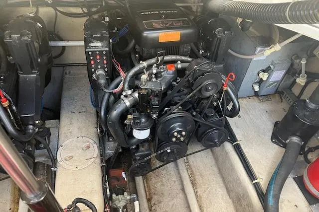 Slide: The Image of Engine compartment of a 1997 Regal Commodore 322 boat, featuring Volvo Penta components. - 26