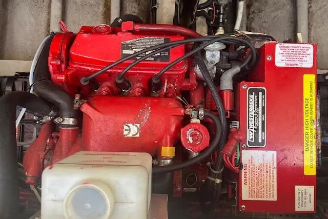 Slide: The Image of Red engine of a 1997 Regal Commodore 322 boat, featuring detailed components. - 28