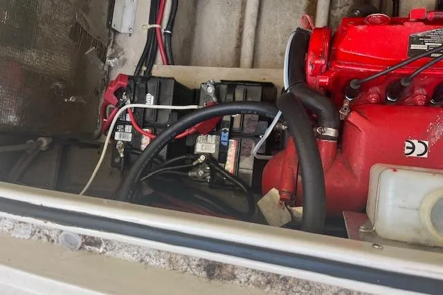 Slide: The Image of Engine compartment of a 1997 Regal Commodore 322 boat with visible batteries and wiring. - 29