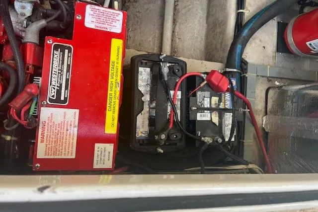 Slide: The Image of Engine compartment of a 1997 Regal Commodore 322 with battery and electrical components. - 30