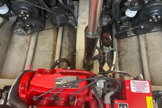 Slide: The Image of Engine compartment of a 1997 Regal Commodore 322 boat, featuring a red engine and mechanical components. - 31