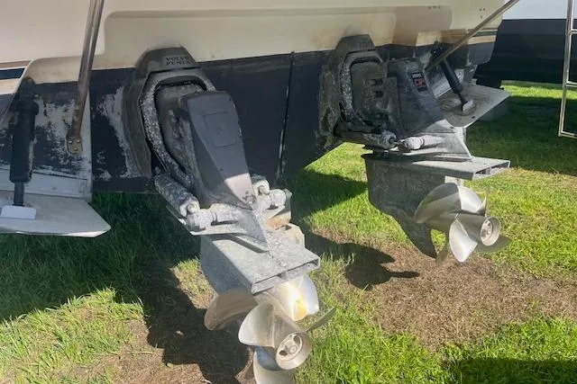 Slide: The Image of Twin propellers of a 1997 Regal Commodore 322 boat on grass. - 4