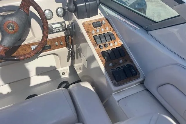 Slide: The Image of Interior view of a 1997 Regal Commodore 322 boat cockpit with control panel and steering wheel. - 7