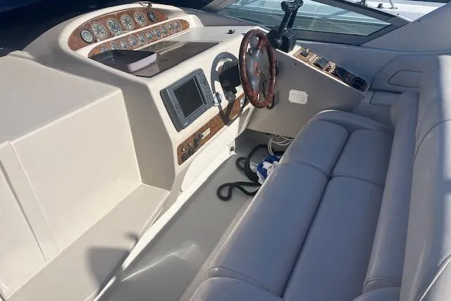 Slide: The Image of 1997 Regal Commodore 322 boat cockpit with steering wheel and control panel. - 9