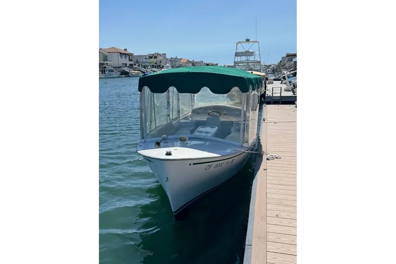 Slide: The Image of 2001 Duffy Classic 21 boat docked with green canopy in sunny marina. - 4
