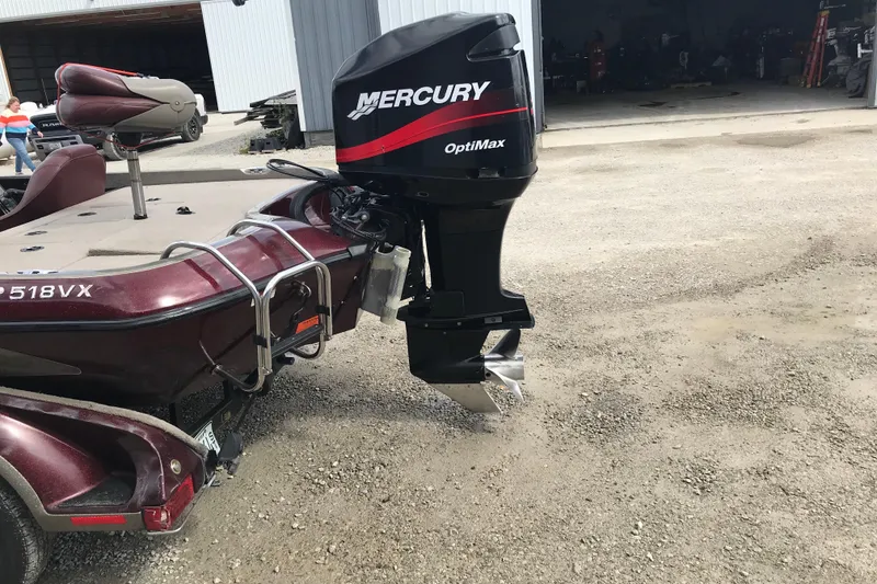 Slide: The Image of 2001 Ranger 518DVX Comanche boat with Mercury OptiMax engine, parked outdoors. - 10