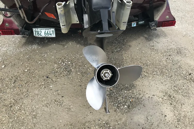 Slide: The Image of Propeller of a 2001 Ranger 518DVX Comanche boat on gravel surface. - 12