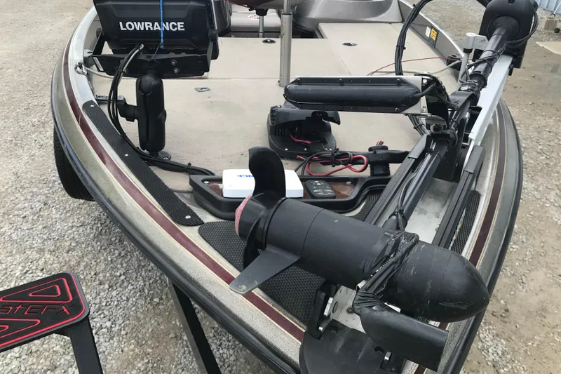 Slide: The Image of 2001 Ranger 518DVX Comanche boat with Lowrance electronics and trolling motor on gravel surface. - 14