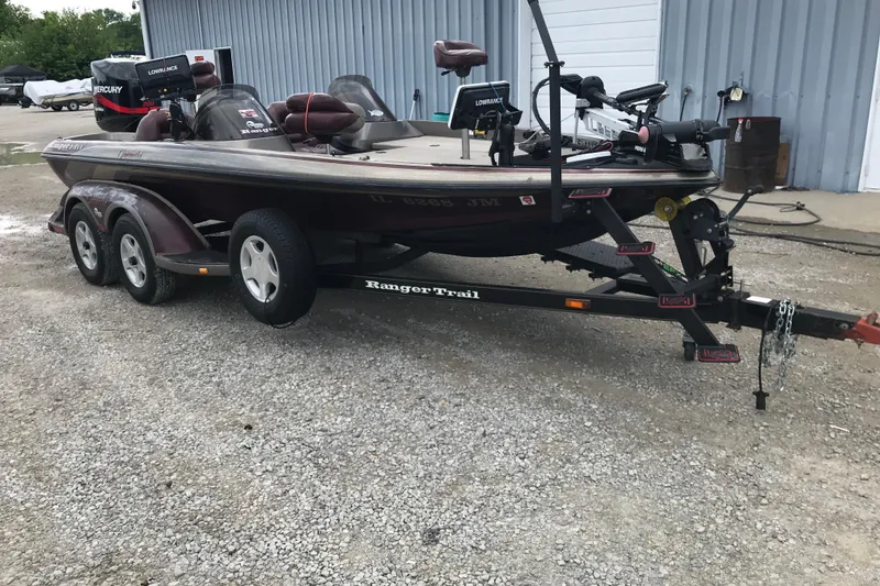 Slide: The Image of 2001 Ranger 518DVX Comanche boat on trailer, parked outdoors. - 16