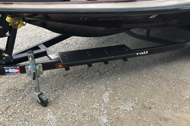 Slide: The Image of Trailer of 2001 Ranger 518DVX Comanche boat on gravel surface. - 18