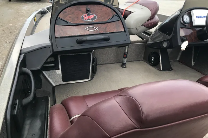 Slide: The Image of 2001 Ranger 518DVX Comanche boat interior with maroon seats and dashboard details. - 24