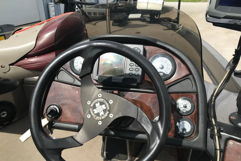 Slide: The Image of 2001 Ranger 518DVX Comanche boat dashboard with steering wheel and gauges. - 25