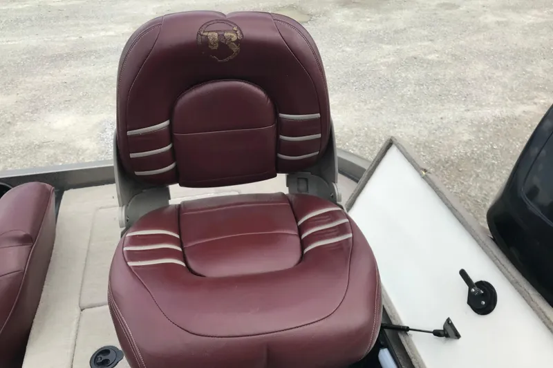 Slide: The Image of Maroon leather seat in 2001 Ranger 518DVX Comanche boat, featuring embroidered logo. - 28