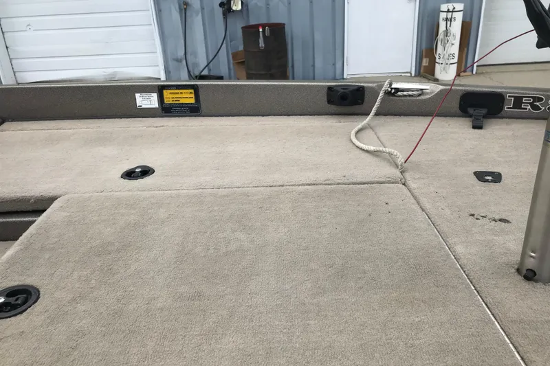 Slide: The Image of 2001 Ranger 518DVX Comanche boat deck with beige carpet and rope detail. - 31