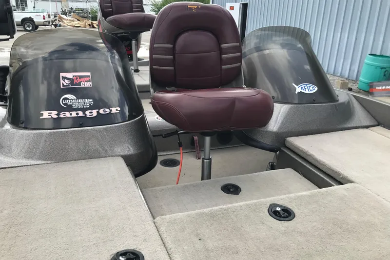 Slide: The Image of 2001 Ranger 518DVX Comanche boat interior with maroon seats and branded decals. - 36