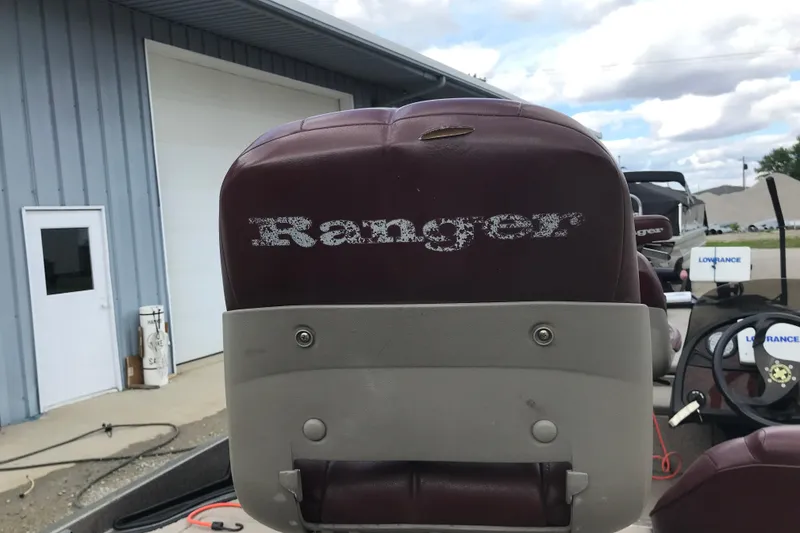 Slide: The Image of 2001 Ranger 518DVX Comanche boat seat with faded logo, parked near a building. - 38